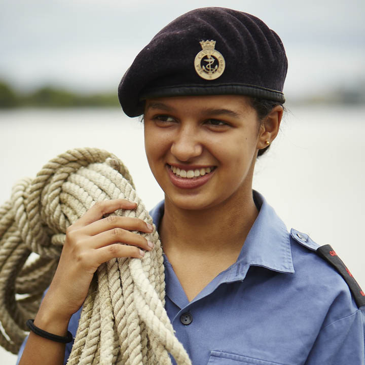 Girl Sea Cadet smiling and carrying rope